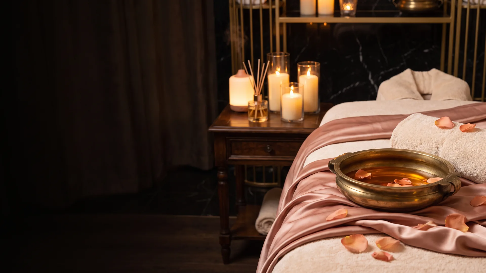 Rose-gold silk, massage oil and candles prepared for a sensual massage in London